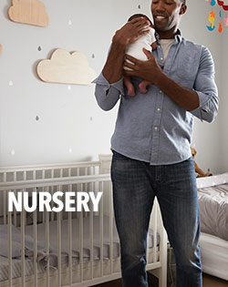 FATHER HOLDING BABY IN NURSERY