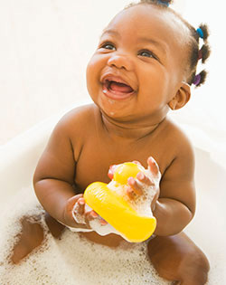 BABY SMILING WITH RUBBER DUCK