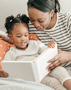 MOTHER AND DAUGHTER READING A BOOK